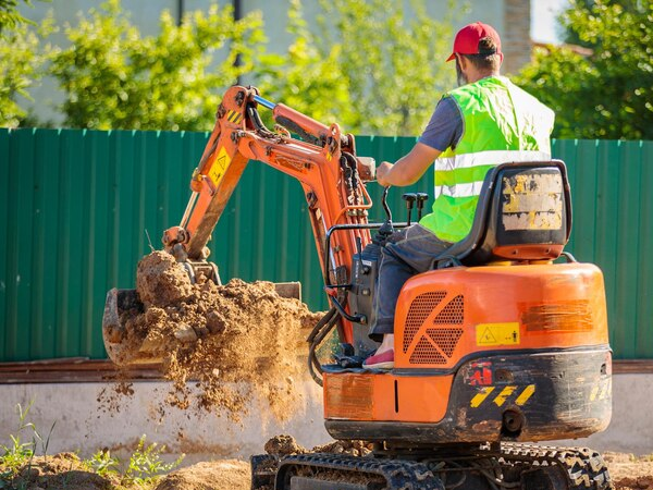 Mini excavator with an operator